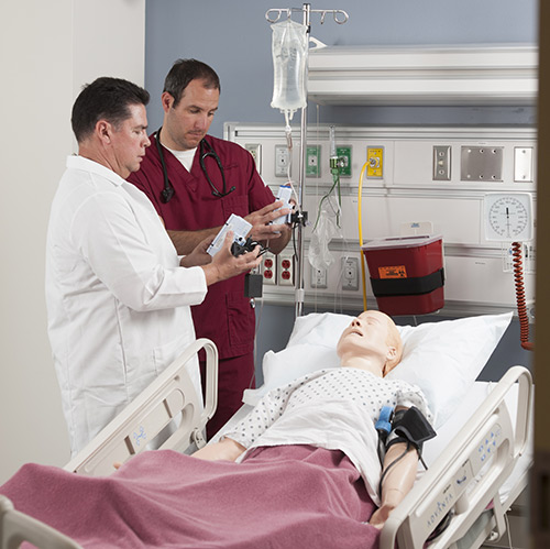 Two healthcare workers learning with a simulated patient