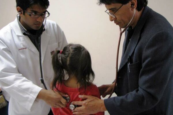 Dr. Juan F. Castro, Assistant Professor Of Pharmacy Practice, And Jacob George, Third-year Professional Student Pharmacist, Check A Patient In Alton, Texas, During Project SHINE.