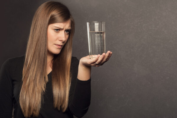 Photo Of Woman Looking At Glass Of Water