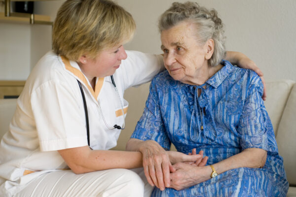 Geriatric Nurse Caring For An Older Woman