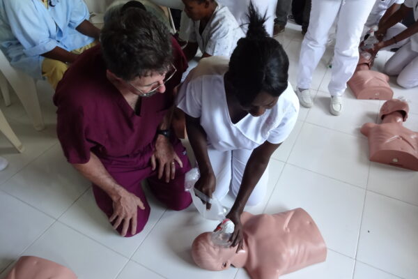 COM Professor Teaching CPR In Haiti