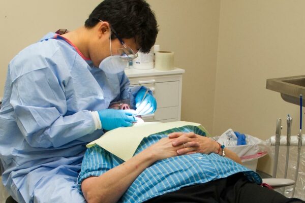 Fourth-year Dental Student Ethan Yang Treats A Patient At North Dallas Shared Ministries In June 2014.