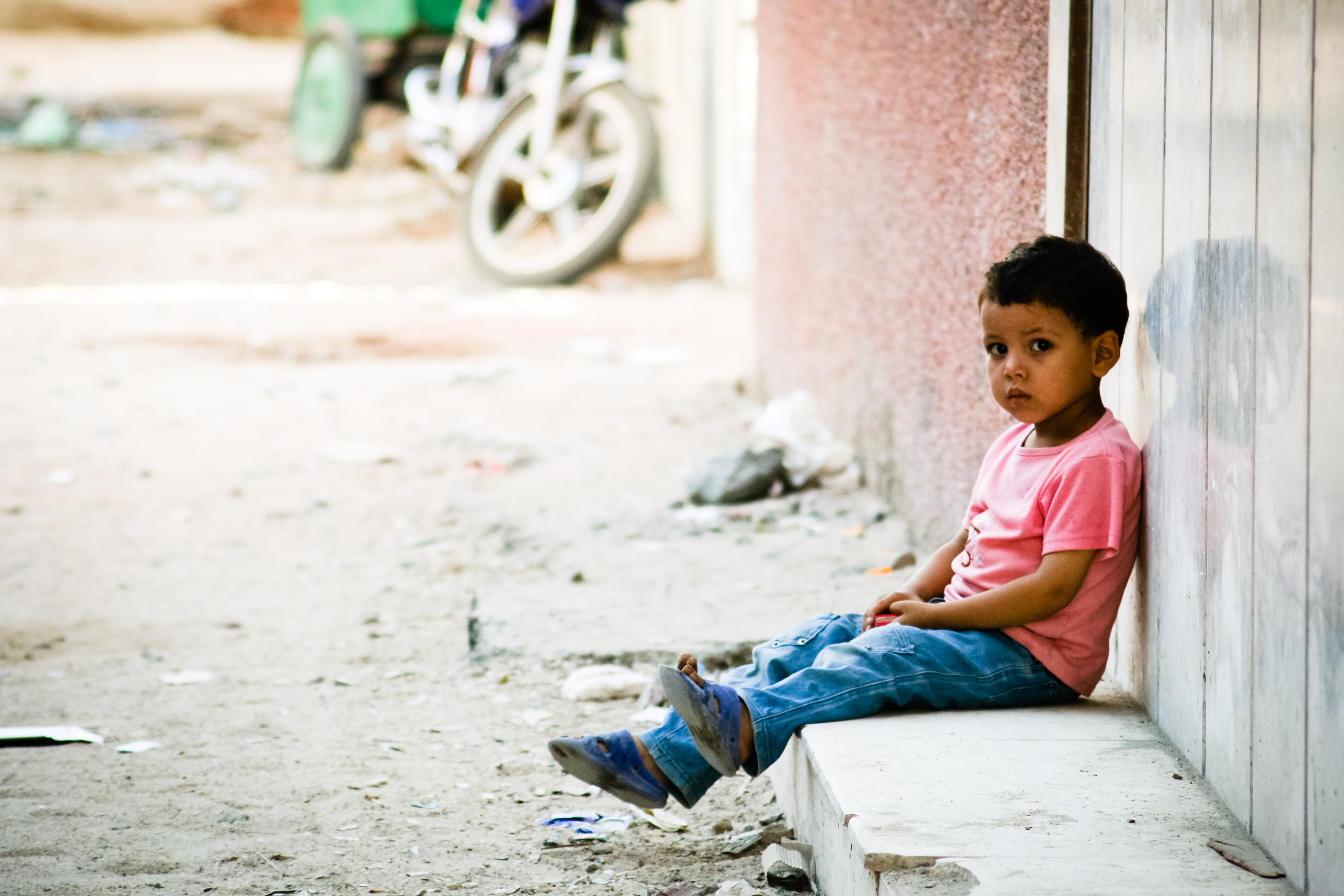 Boy waiting outside building