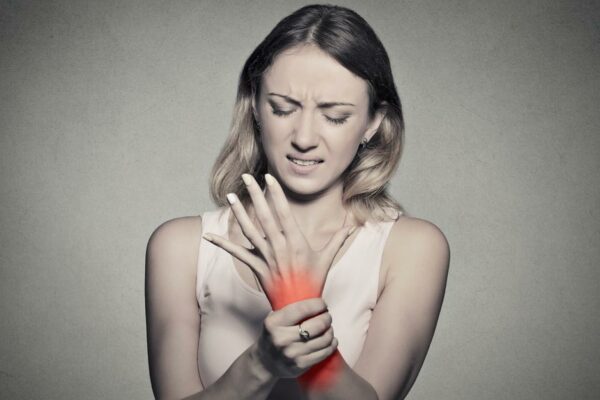 Young Woman Holding Her Wrist