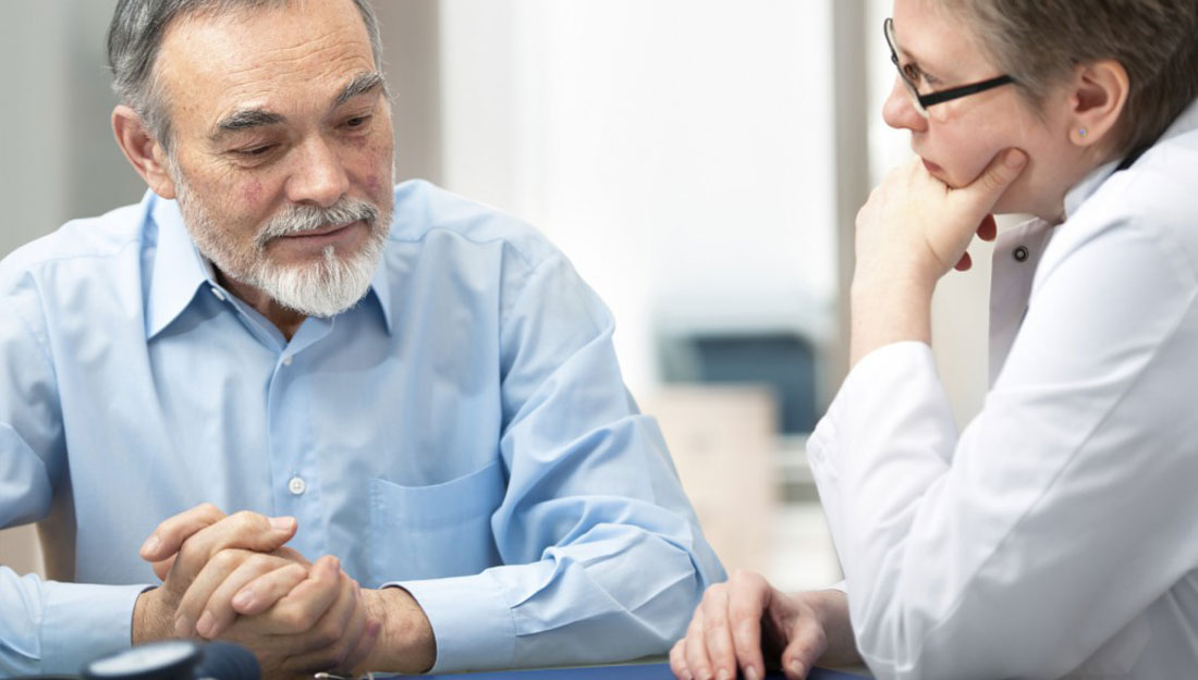 Doctor talking to her male patient at office