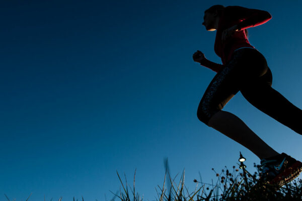 Girl Running On The Grass