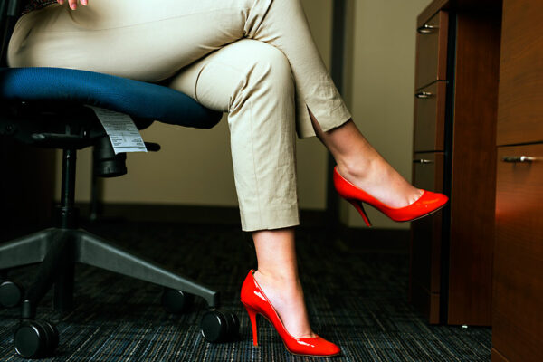 Woman At Desk In Bright Orange High Heels.