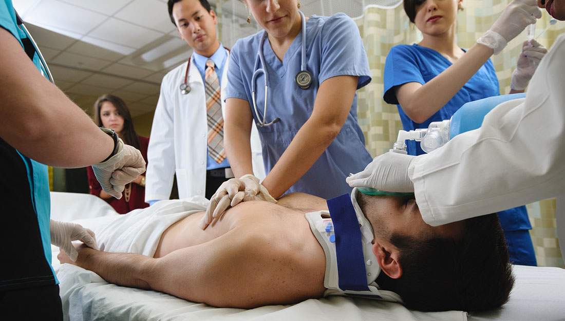 Different health professionals working on patient