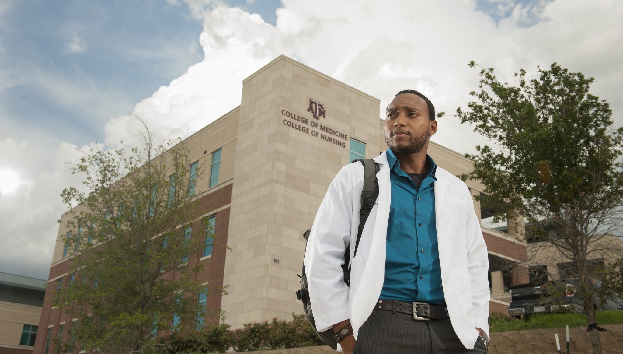 Medical student standing in front of College of Medicine building