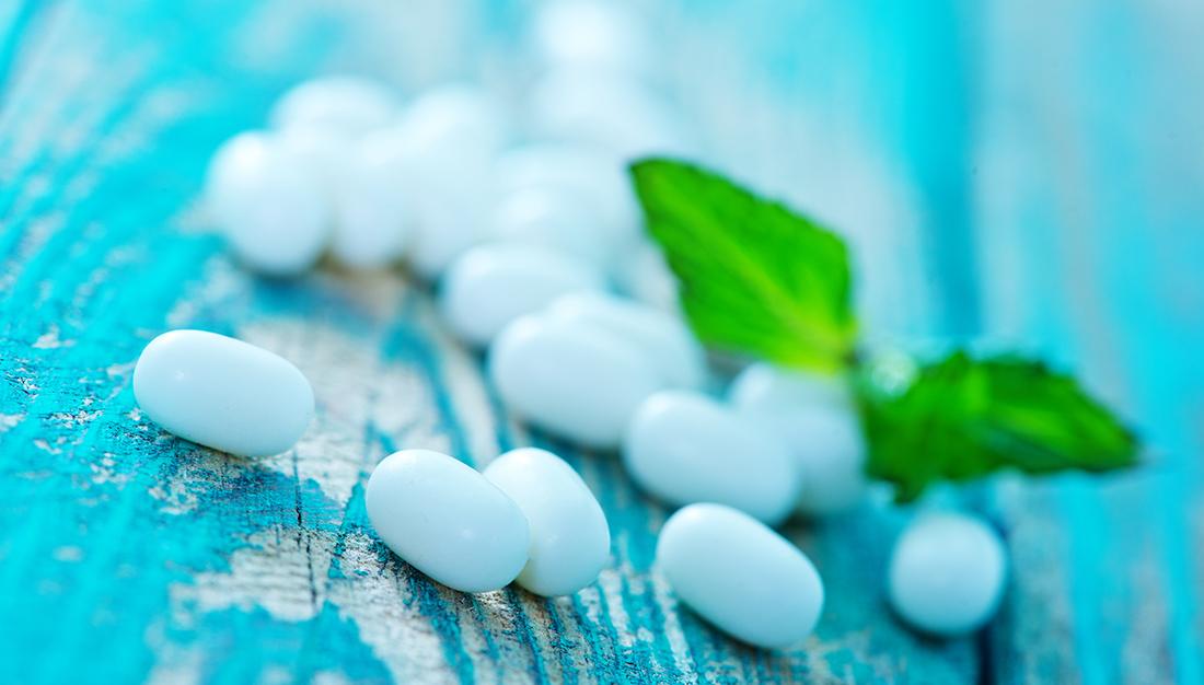 Mint candies and mint leaves on a table