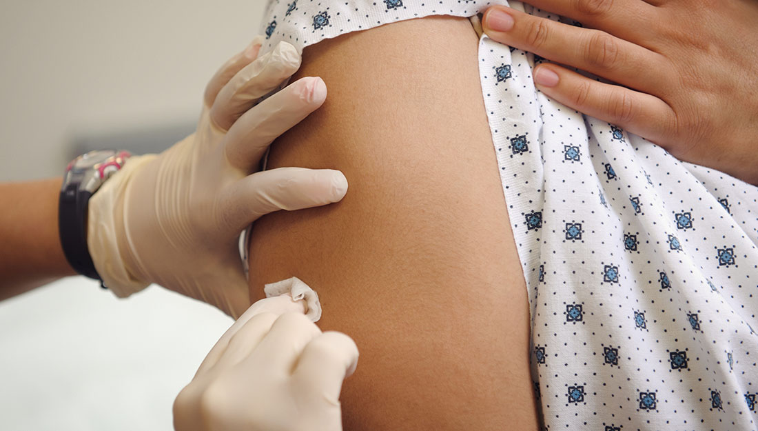 adult getting a vaccine, immunization by nurse