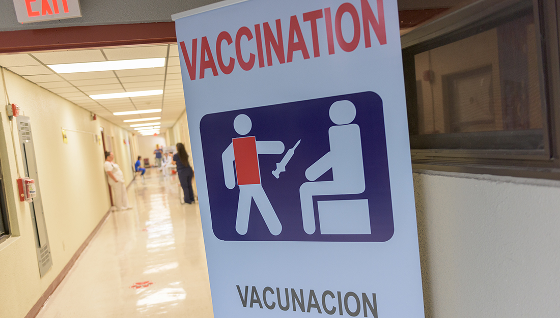 Measles comeback - Measles, mumps and rubella vaccination sign pointing to a clinic