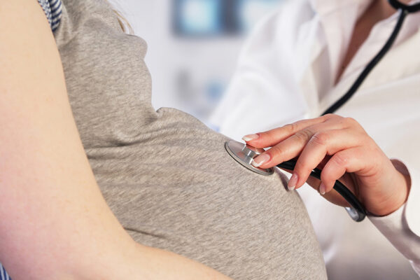 Stillbirth Research. Doctor Examining A Pregnant Woman, Post Stillbirth.