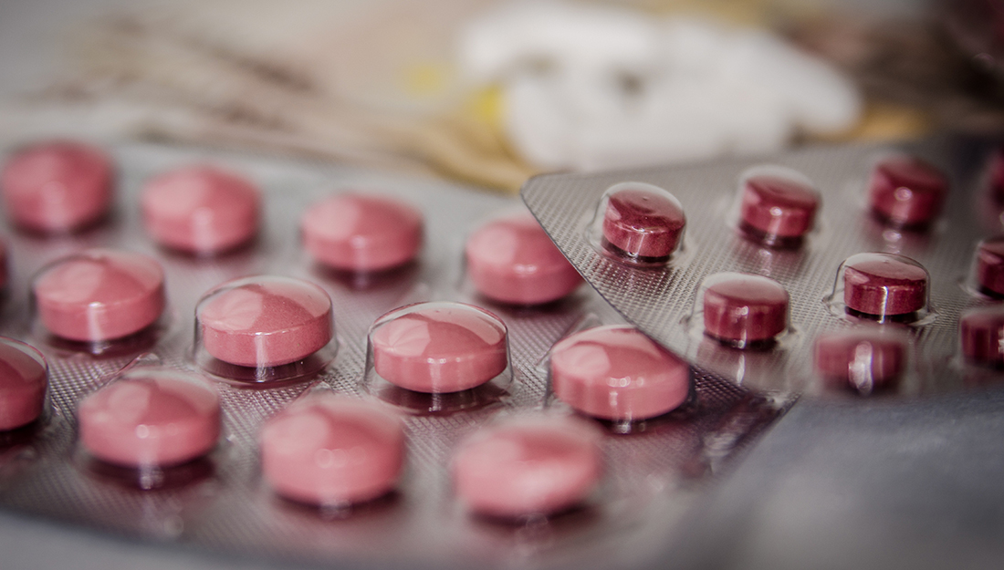 Anti-anxiety medication - small red pills in a silver container