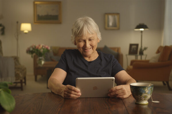 Woman Smiling While Looking At IPad