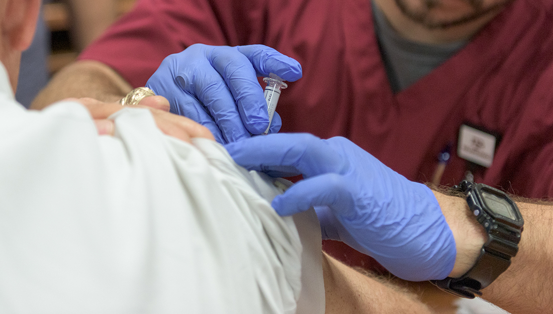 Vaccines_Acetaminophen_immune response_A nurse administers a vaccine on a patient's shoulder