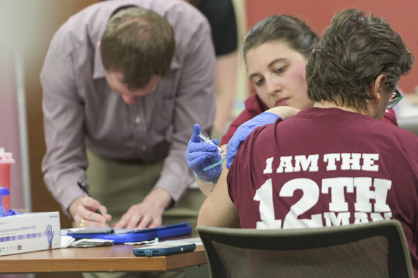 Flu Vaccine Clinic_A Student Administers A Flu Shot To A Texas A&M Employee