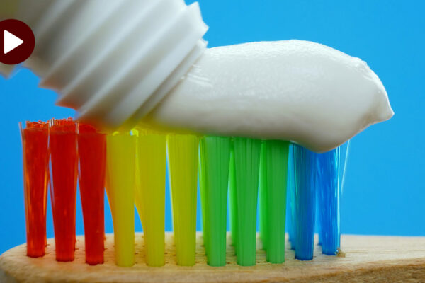 How Do I Choose The Right Toothbrush? An Image Of A Rainbow Colored Toothbrush With Toothpaste On Top