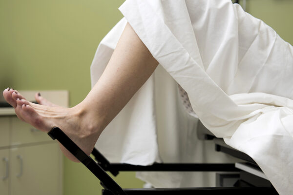 A Woman Is Lying Down With Her Feet In An Elevated Position