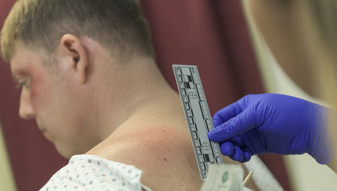 Male patient being checked by a forensice nurse