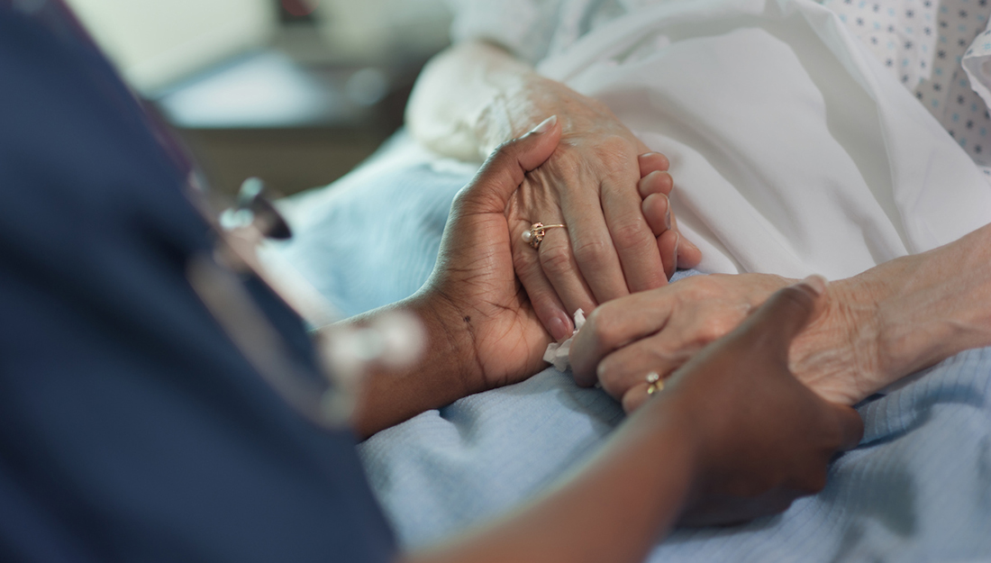 nurse comforting older patient