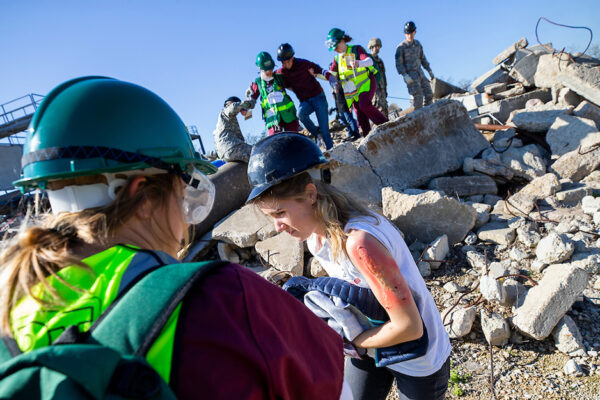 Health Students Assist Mock Patients From Rubble