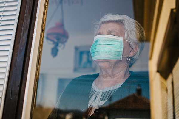 Close-up Picture Of An Old Woman In Self-isolation Stares Anxiously