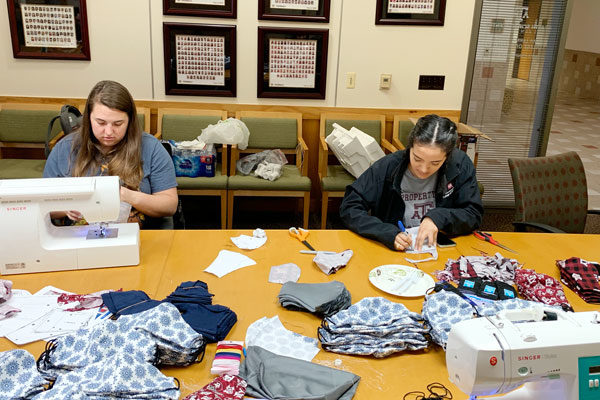 two Texas A&M pharmacy students sew face masks