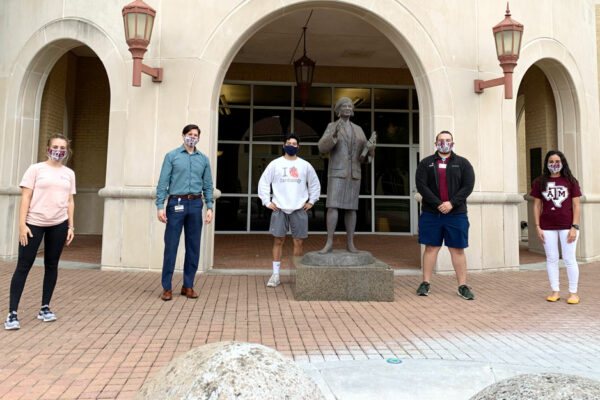 Five Students Pose In Front Of Rangel College Of Pharmacy Building Wearing Hand-sewn Face Masks