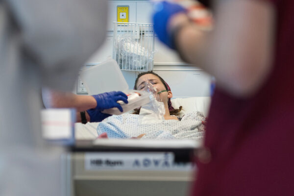 Person In Hospital Bed Receiving Medical Intervention