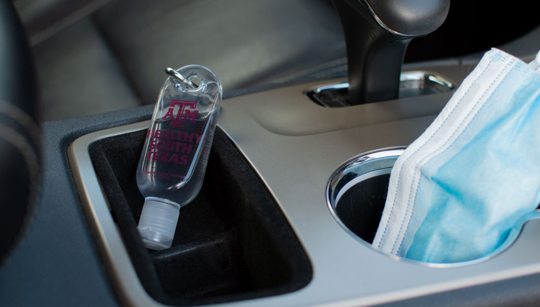 bottle of hand sanitizer in a car center console