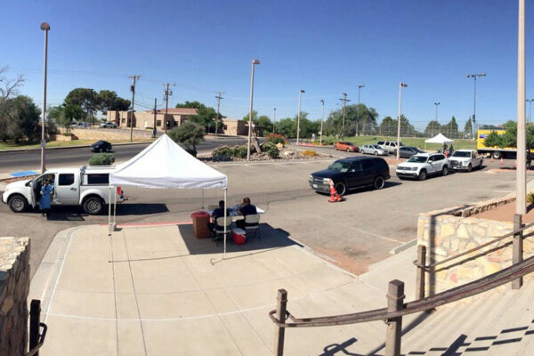 View Of Drive-through Testing Site With Cars Lined Up Around The Parking Lot