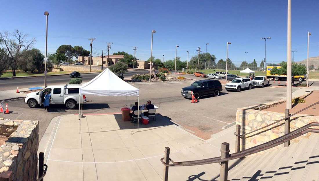 View of drive-through testing site with cars lined up around the parking lot