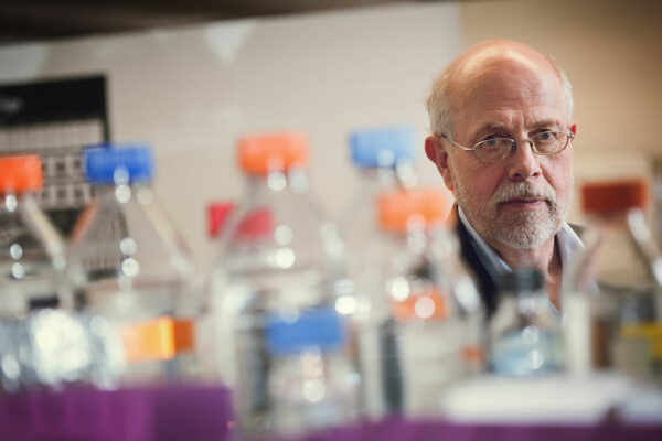 Magnus Hook Stands In A Laboratory, Looking Directly At Camera