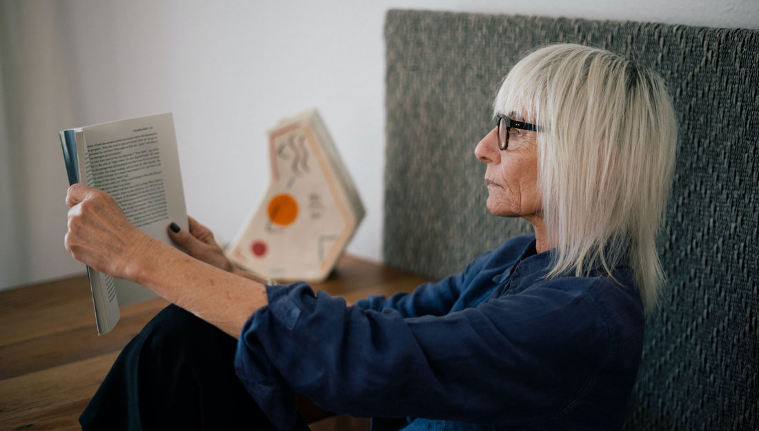 older woman reading a book