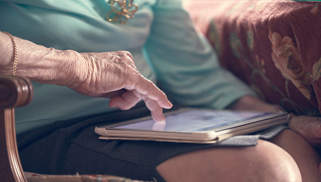 older woman reading on a tablet