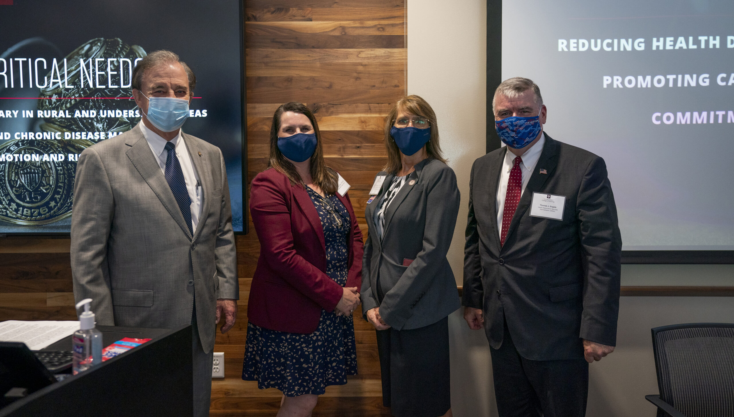 Photo of Chancellor John Sharp, Dr. Jodie Gary, Dr. Nancy Downing and HRSA Administrator Thomas J. Engels standing together with face masks on