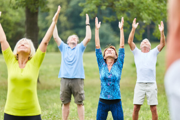 Older Adults Exercise In A Group Outside