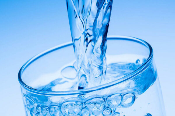 Close-up Of Water Being Poured Into A Glass