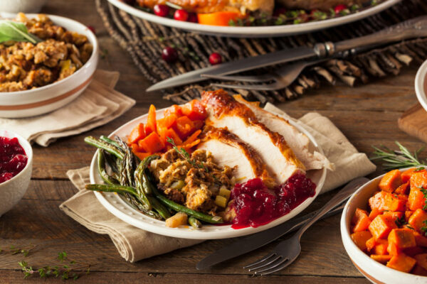 Table Full Of Thanksgiving Food, Plate Of Turkey, Stuffing, Sweet Potatoes, Asparagus And Cranberry Sauce