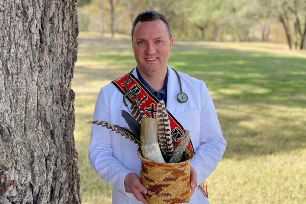 R. Cody Bruce Wears White Coat And Tribal Regalia