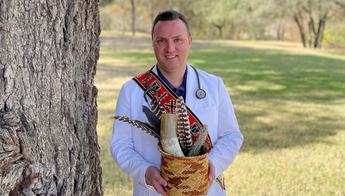 R. Cody Bruce wears white coat and tribal regalia