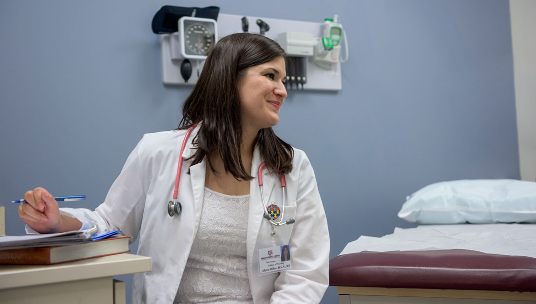 Graduate nursing student sits in a clinic exam room