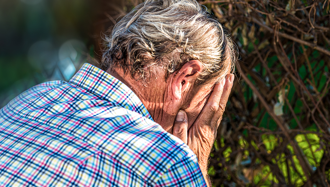 Older man worried and hiding his face in his hands. Headache. Ad