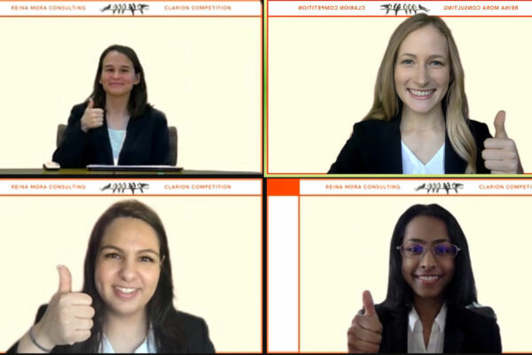 Screenshot Of A Zoom Call With Four Students Giving A "gig 'em" Sign