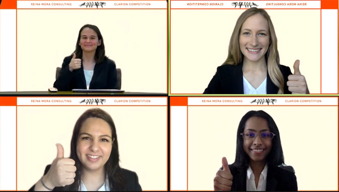 screenshot of a Zoom call with four students giving a "gig 'em" sign