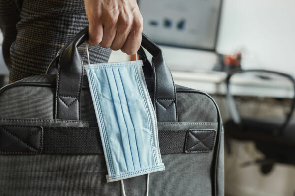 Man With A Briefcase And A Surgical Mask