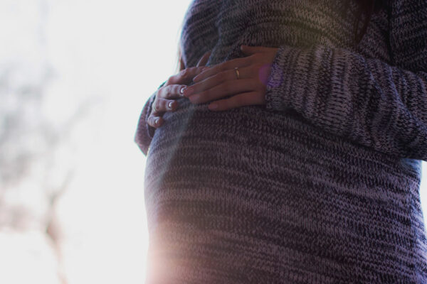 Pregnant Woman Stands Outside