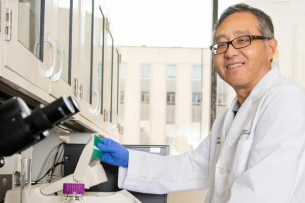 Dr. Feng Tao Sits In A Laboratory