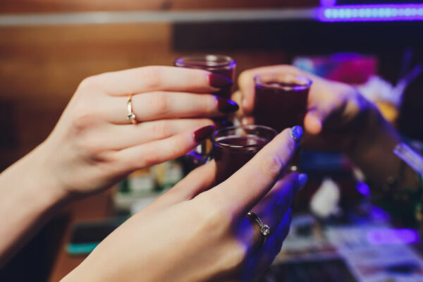 Group Of Females Toasting Shot Glasses